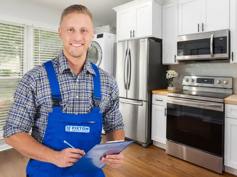 Contact Fixton Appliance Services - a friendly appliance repair technician holds a clipboard and ready to help.