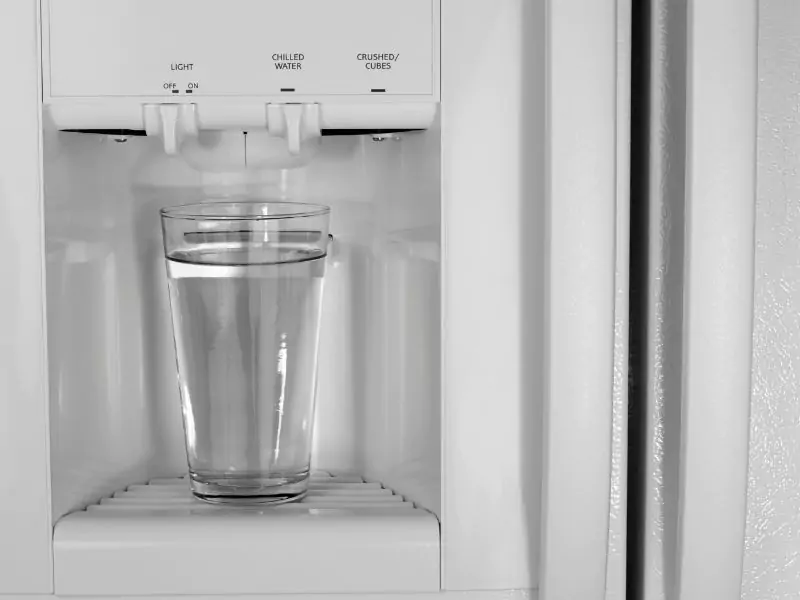 Refrigerator water dispenser with glass of water