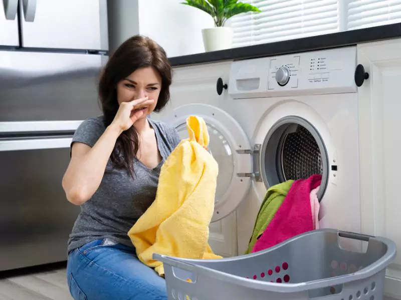 Young Woman is not happy with washing machine smell